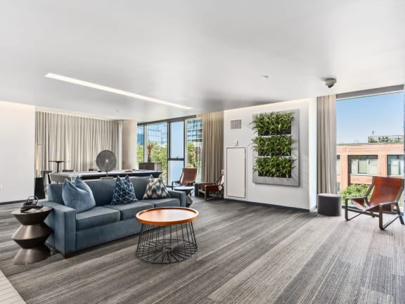 a living room with a blue couch and a coffee table at One 333, Illinois, 60605
