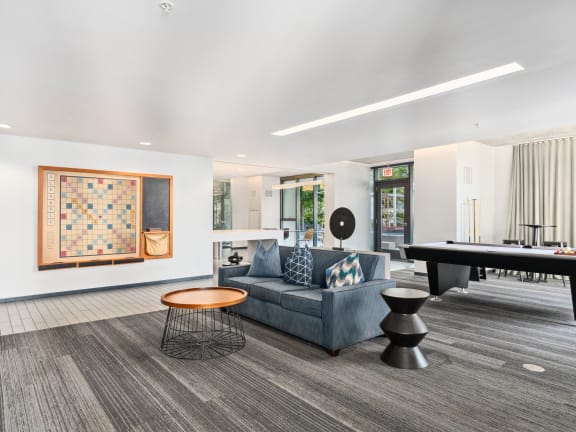 a living room with a couch and a pool table at One 333, Chicago, IL