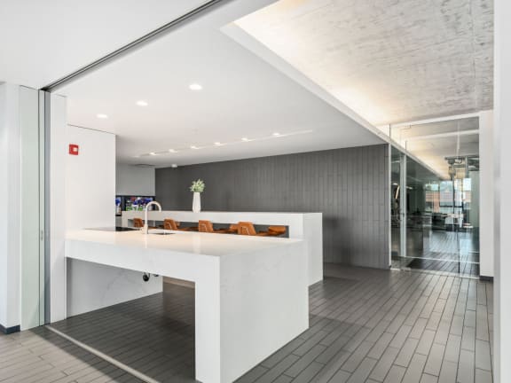 an open office area with a white counter and a glass door at One 333, Chicago, 60605