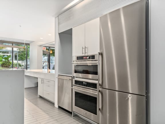 a kitchen with stainless steel appliances and white cabinets at One 333, Chicago, Illinois