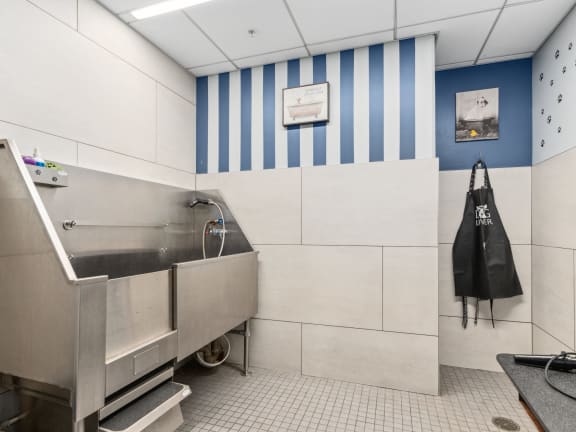 a large stainless steel sink in a kitchen with blue and white striped walls at One 333, Chicago, Illinois, 60605