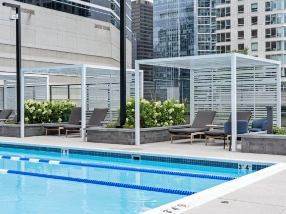 a swimming pool with chairs and a building in the background  at Cassidy on Canal, Illinois, 60606