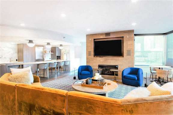 A living room with a fireplace and a television.