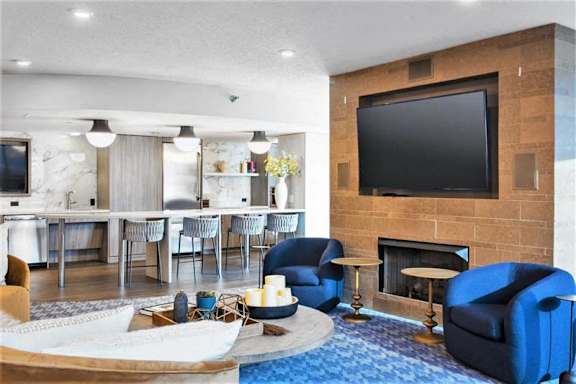 A living room with a fireplace and a television.