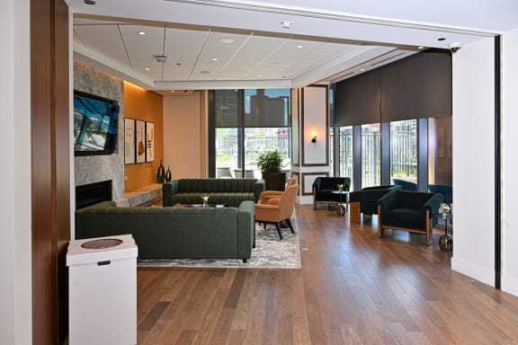 a large lobby with couches chairs and a fireplace  at Cassidy on Canal, Chicago, Illinois