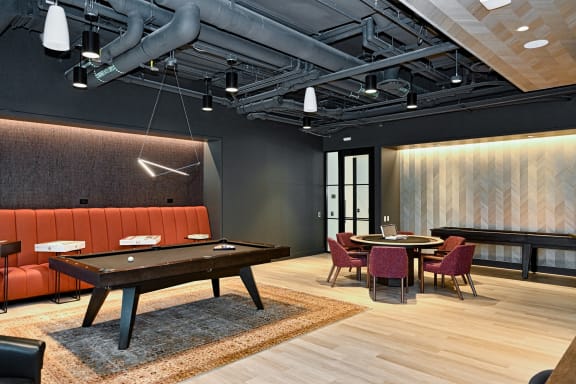 a large room with a pool table and tables and chairs  at Cassidy on Canal, Chicago