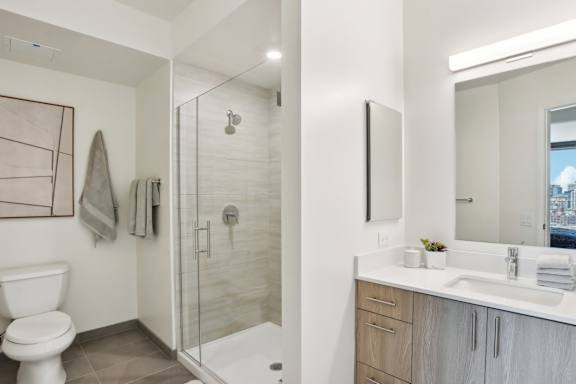 A bathroom with a toilet, sink, and shower.