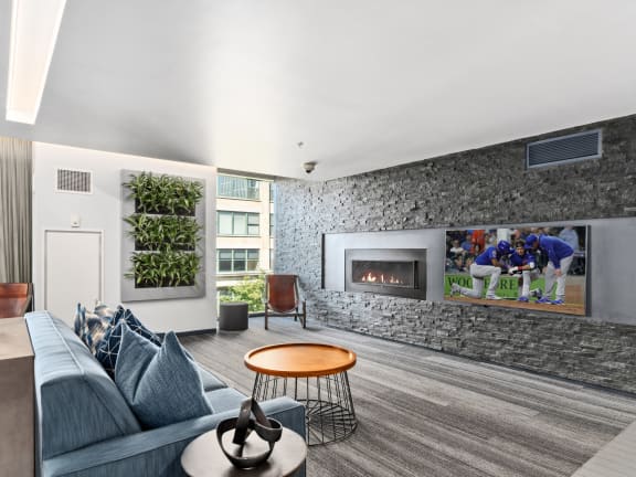 a living room with a fireplace and a tv on the wall at One 333, Chicago, IL