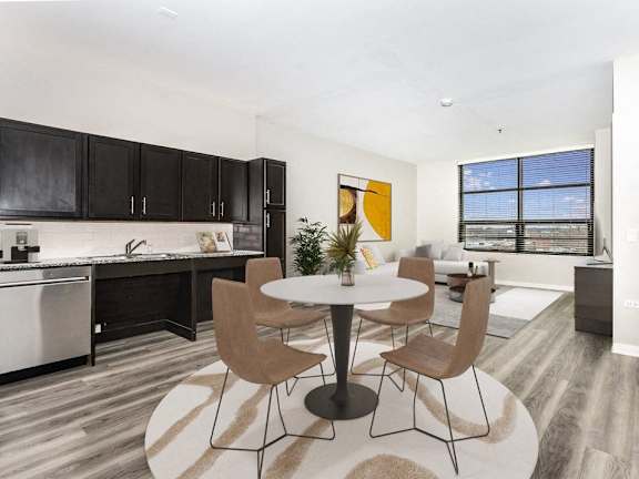 A modern kitchen with a dining table and chairs.