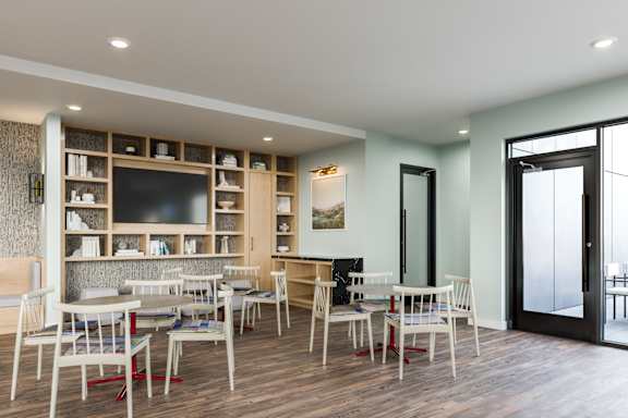 A modern dining room with a wooden table and chairs.