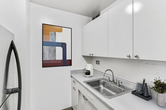 a kitchen with white cabinetry and a sink at The Pavilion, Michigan