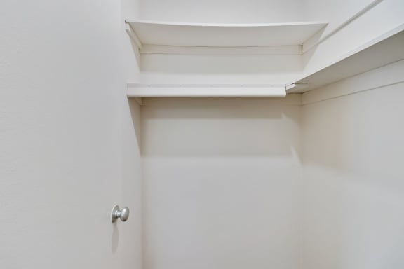 a walk in closet in a bedroom with white walls and a white ceiling with a skyl at The Pavilion, Michigan
