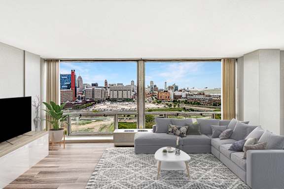 A modern living room with a large window overlooking a cityscape.