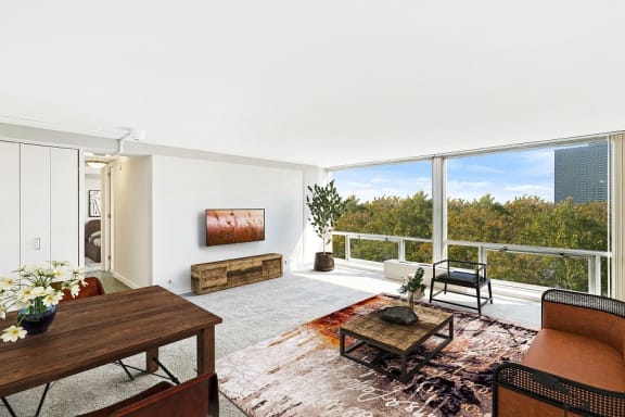 a living room with a large window and a view of the city at The Pavilion, Detroit, MI, 48207