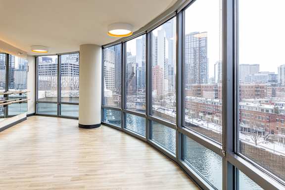 A large room with a view of the city through the windows.