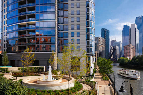 A modern building with a fountain in front of it.