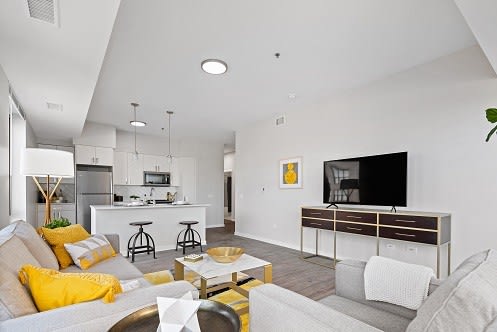 a living room filled with furniture and a flat screen tv