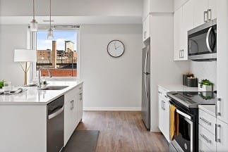 a kitchen with a stove top oven next to a window