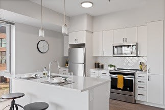 a kitchen with a stove a refrigerator and a sink