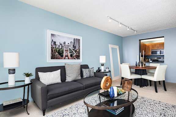 a living room with a couch a coffee table and a dining room table at Columbus Plaza, Chicago, IL, 60601