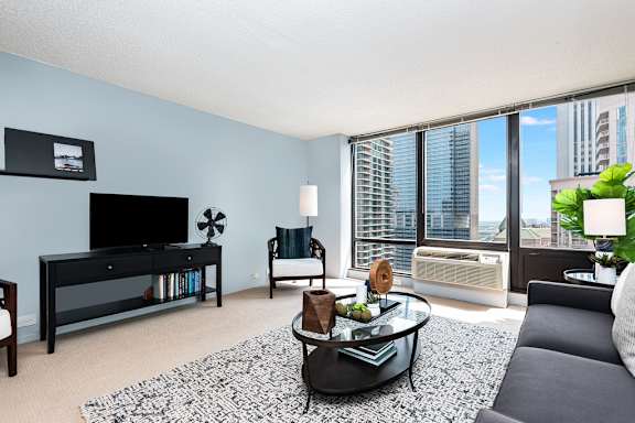 a living room with a large window and a large rug at Columbus Plaza, Chicago, Illinois