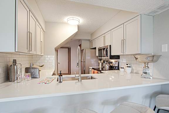 A kitchen with white countertops and cabinets at Seasons Villas, Woodbury, MN