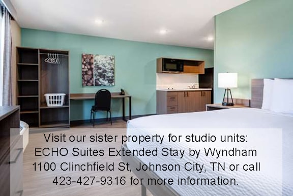 A room with a desk and a chair is shown with text advertising ECHO Suites Extended Stay by Wyndham.