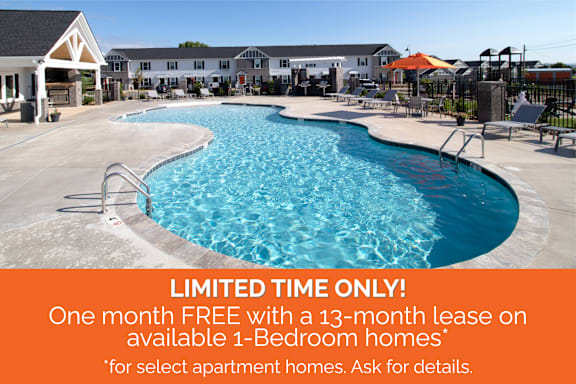 A pool with a sign offering a free month with a lease.