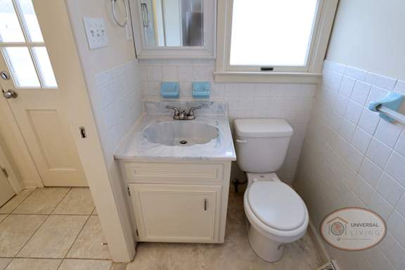 A white bathroom with a toilet and sink.