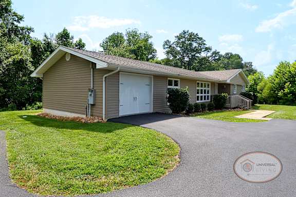 A grey home with an attached garage.