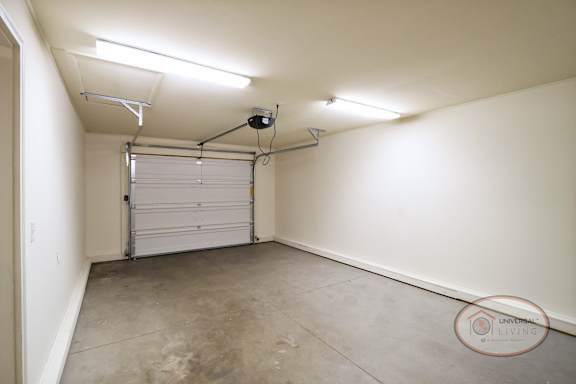 The interior of the garage with white walls and overhead lights.