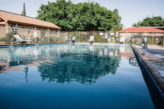 Swimming pool with reflection and patio furniture at Cantera Apartments, Texas, 79935