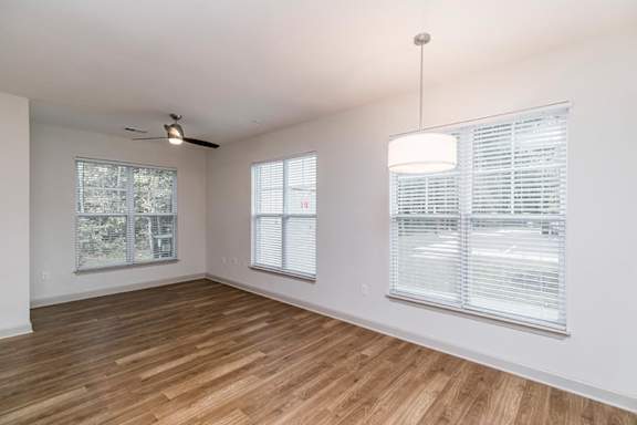 A room with wooden floors and a ceiling fan at 1701 North Apartment Homes Apartments, North Carolina, 27514