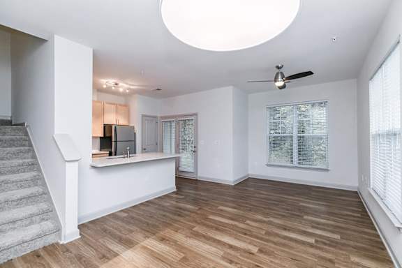 A room with a staircase and a ceiling fan at 1701 North Apartment Homes Apartments, North Carolina, 27514