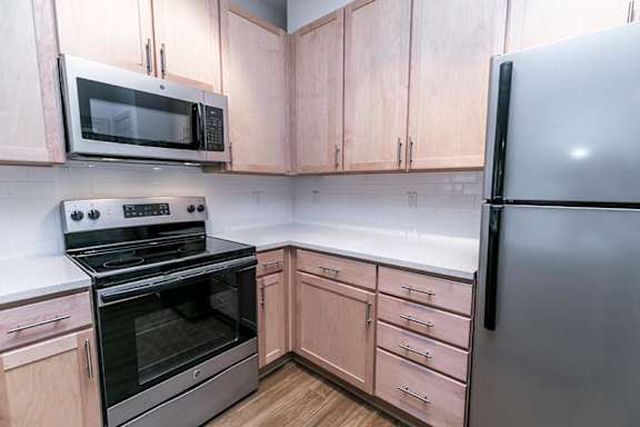 A kitchen with a stove, oven, microwave, and refrigerator at 1701 North Apartment Homes Apartments, Chapel Hill, North Carolina