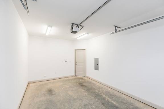 A white door is in a white room with a concrete floor at 1701 North Apartment Homes Apartments, North Carolina