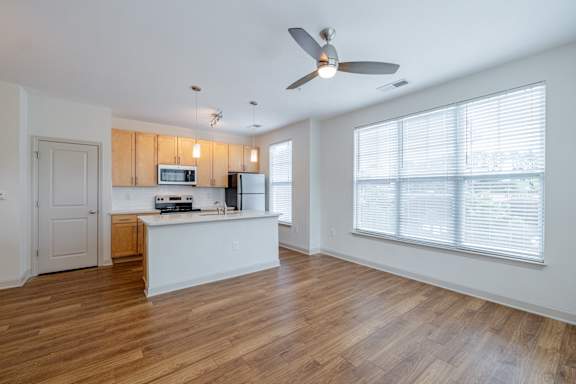 A kitchen with a fan and wooden floors. at 1701 North Apartment Homes Apartments, Chapel Hill, 27514