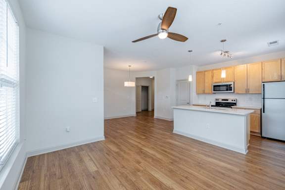A kitchen with a white counter and a refrigerator. at 1701 North Apartment Homes Apartments, Chapel Hill, NC