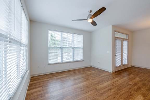A room with a ceiling fan and a window with blinds. at 1701 North Apartment Homes Apartments, Chapel Hill, 27514