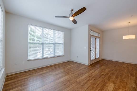 A room with a ceiling fan and wooden flooring at 1701 North Apartment Homes Apartments, Chapel Hill