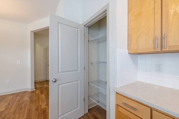 A kitchen with a white door and a white fridge at 1701 North Apartment Homes Apartments, Chapel Hill, NC, 27514