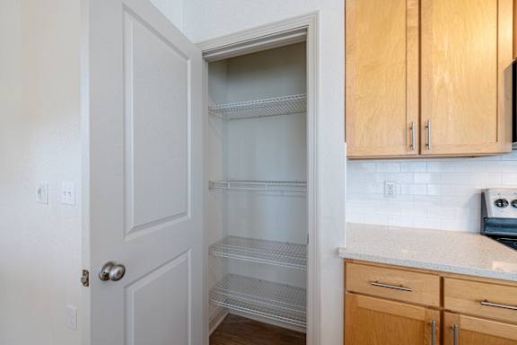 Kitchen with wooden cabinets at 1701 North Apartment Homes Apartments, North Carolina