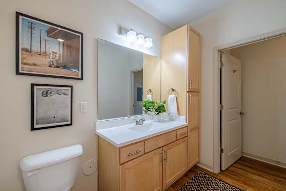 A bathroom with a white sink and a white toilet at 1701 North Apartment Homes Apartments, North Carolina, 27514