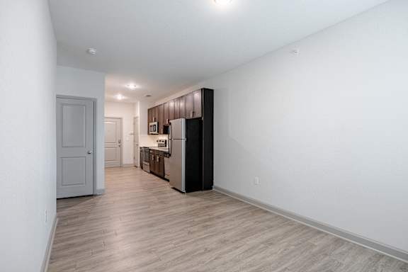 A kitchen with a black fridge and white walls at 1701 North Apartment Homes Apartments, Chapel Hill, 27514