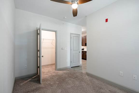 A room with a ceiling fan and a carpeted floor at 1701 North Apartment Homes Apartments, Chapel Hill, North Carolina