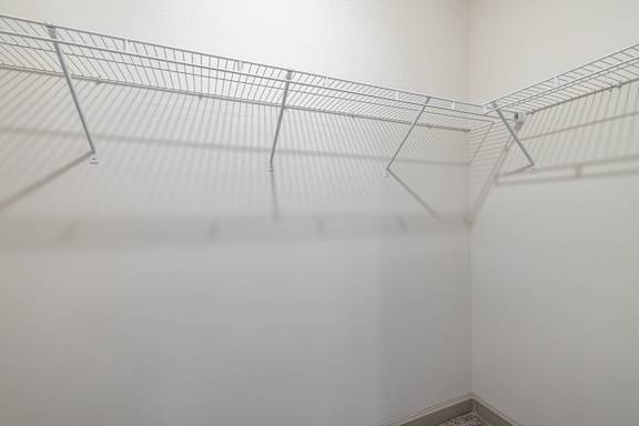 A wire shelf in a white room at 1701 North Apartment Homes Apartments, Chapel Hill, 27514