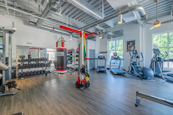 A gym with a variety of equipment including weights, a treadmill, and a rowing machine at 1701 North Apartment Homes Apartments, Chapel Hill, NC, 27514