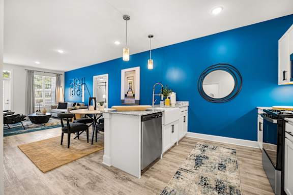 A kitchen with a blue wall and a white counter.