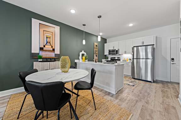 Modern kitchen with dining table set for two at Views at Flowers, Clayton, NC