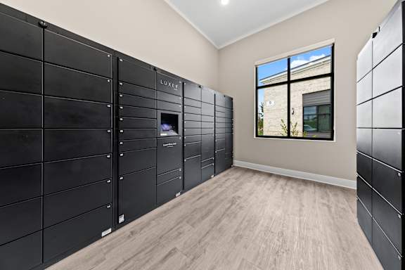Package Room with black lockers at Views at Flowers, Clayton, NC
